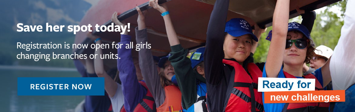 Girls carrying a canoe above head